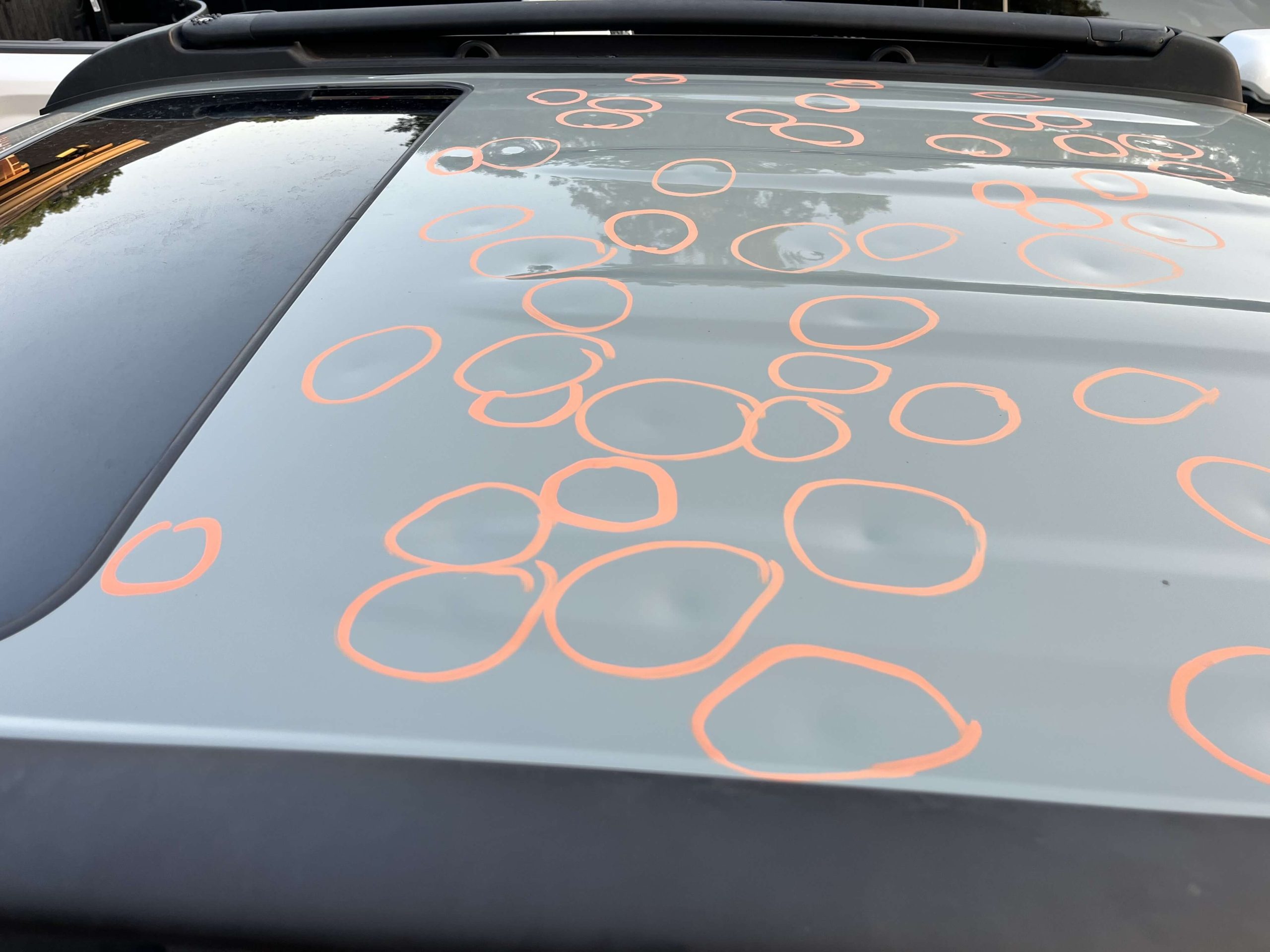 gray car marked with dents